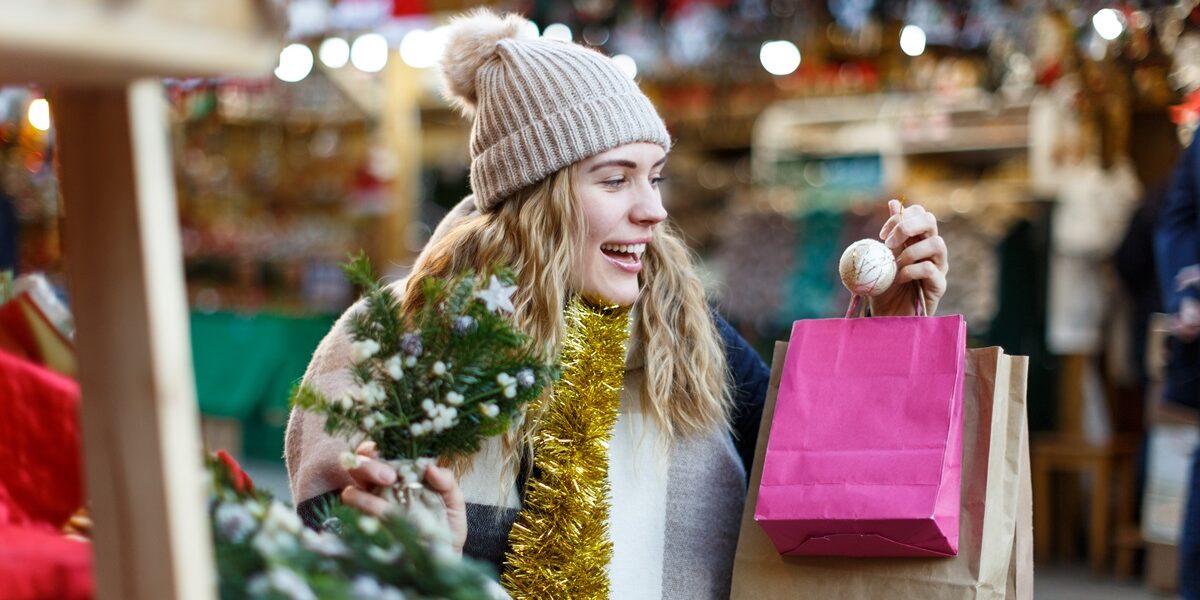 Portrait,Of,Pretty,Girl,With,Paper,Bags,Choosing,Christmas,Toys